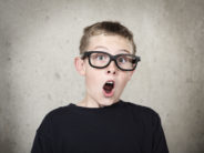 School Expects Parents to Accompany 11-year-olds to Locker. But Why? Surprised boy with black glasses
