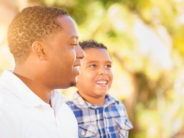 Let Grow Fathers! Mixed Race Son and African American Father Playing Outdoors Together.