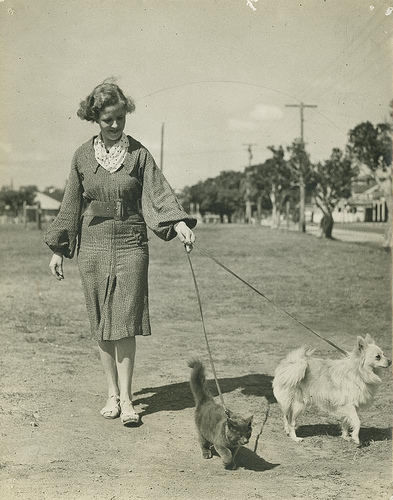 Proto-hipster walks her dog and cat. 