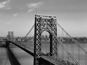 Boy, 10, crosses bridge on bike.