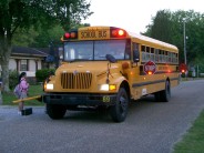 Parents MUST be at the bus stop AND must not leave their other children alone. Hmm. 