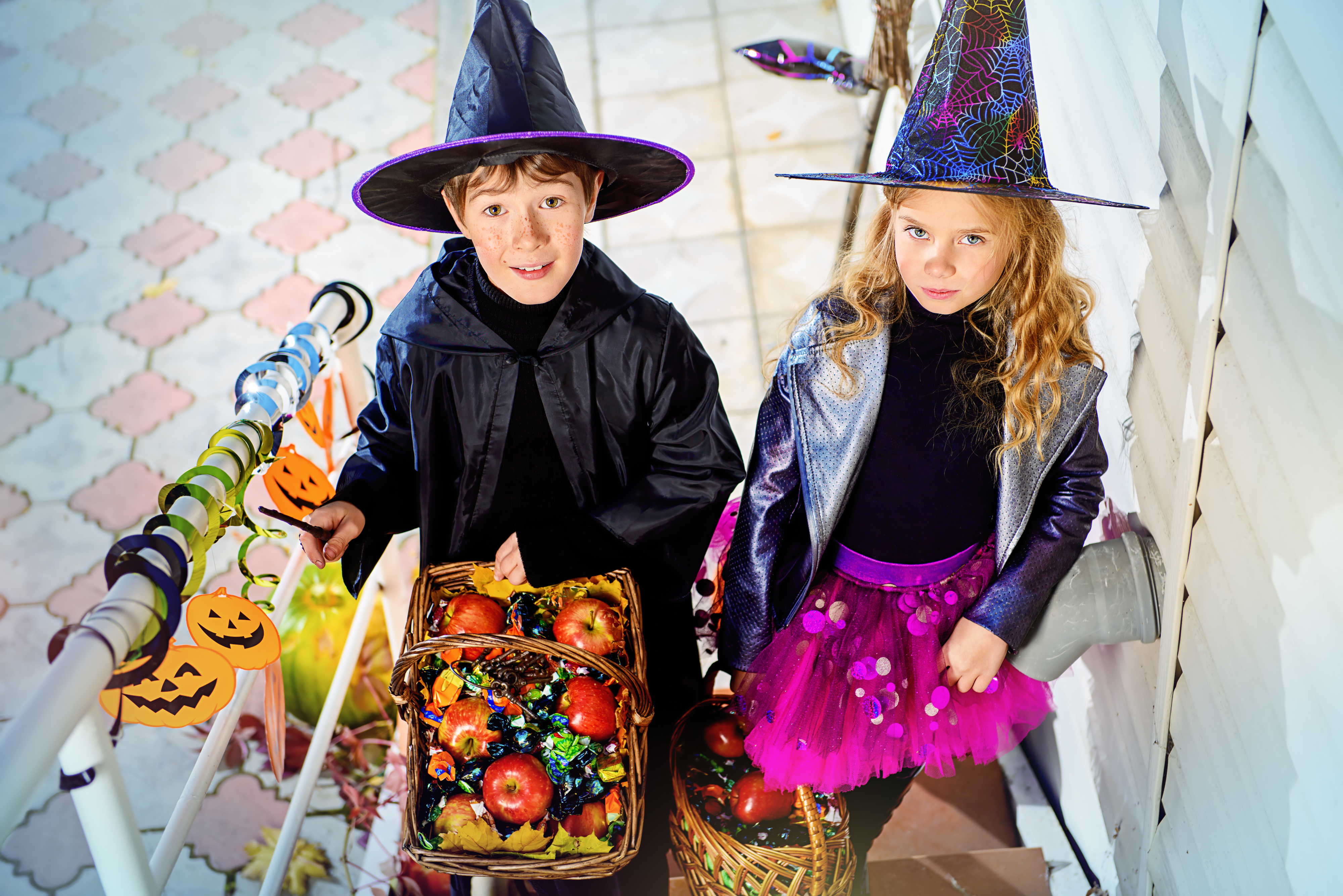 Happy children in a costumes of witches and wizards celebrating halloween. Trick or treat. Halloween party.