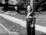 A crossing guard in 1938, when kids, not adults, shepherded students across the street. 