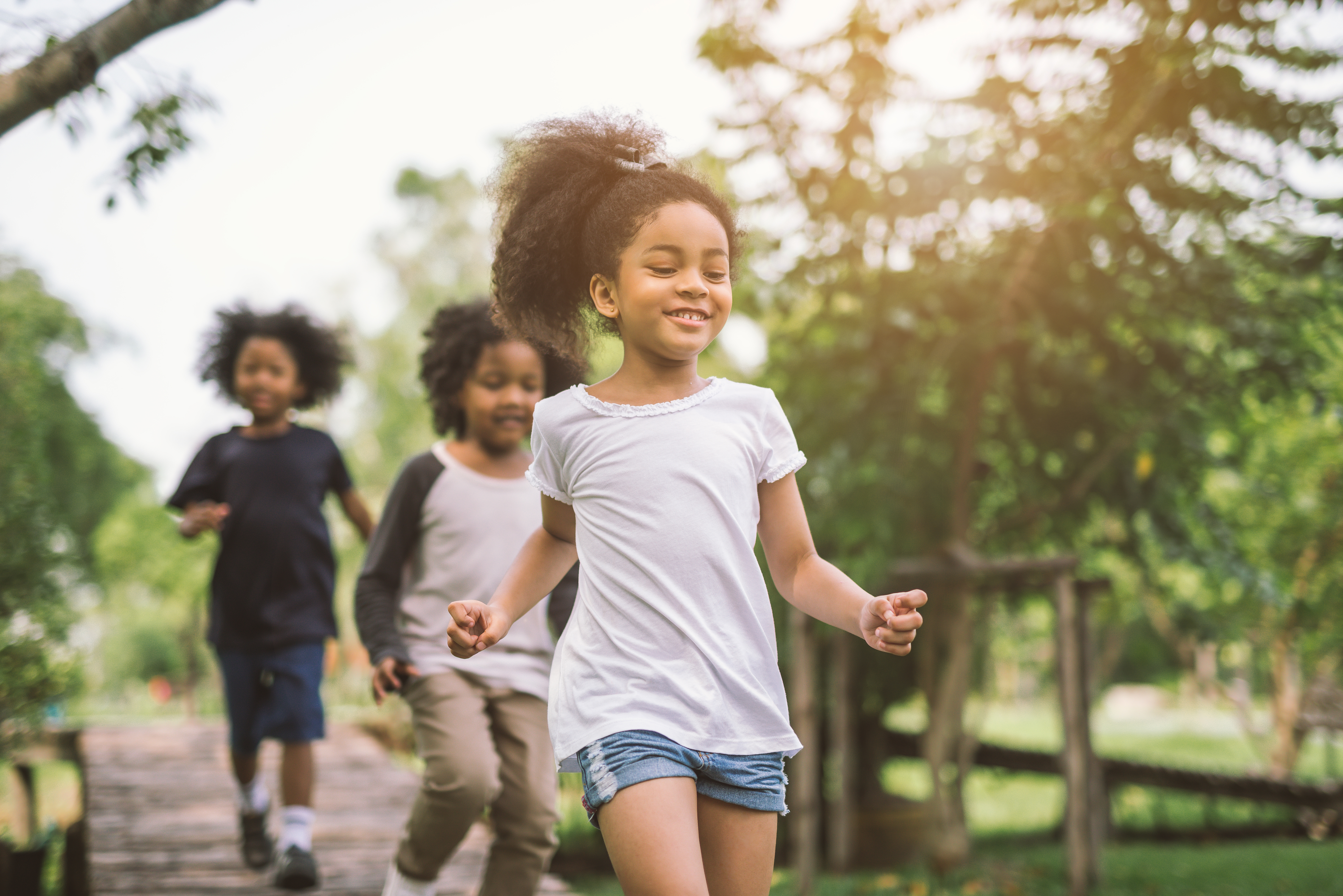 Cute african american little girl playing outdoor - Black people kid and friend happy.