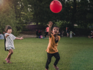 unsplash children playing with big red ball