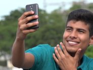Depressed, Anxious Teens Told to Start Spending MORE Time on Social Media Good Looking Teen Boy Taking Selfy And Smiling
