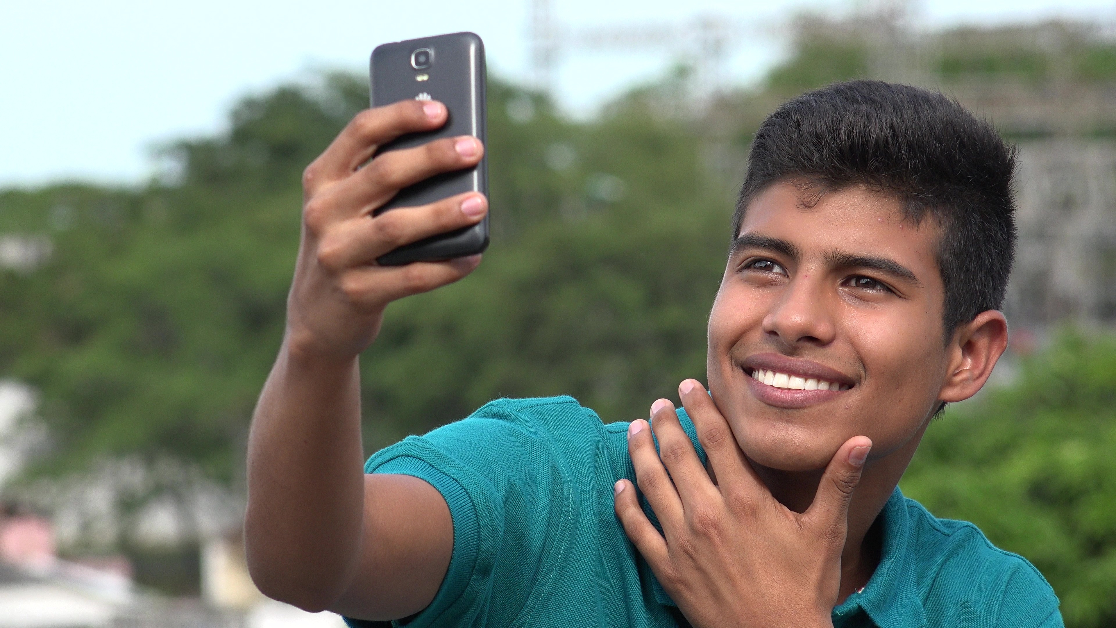Good Looking Teen Boy Taking Selfy And Smiling