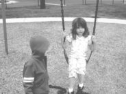 vintage kids on swing poignant