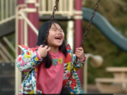 peter gray happy kid on swing